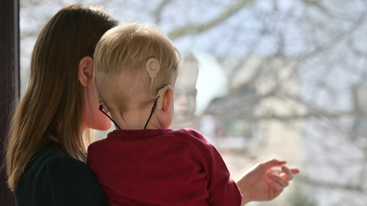 Photo of a mother with a child. Child has a cochlear implant. Photo: Generic/Shutterstock