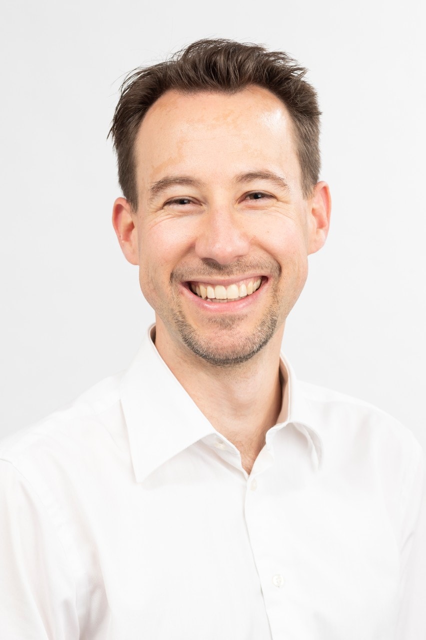 photo of Associate Professor Tom van Laer, smiling on a white background