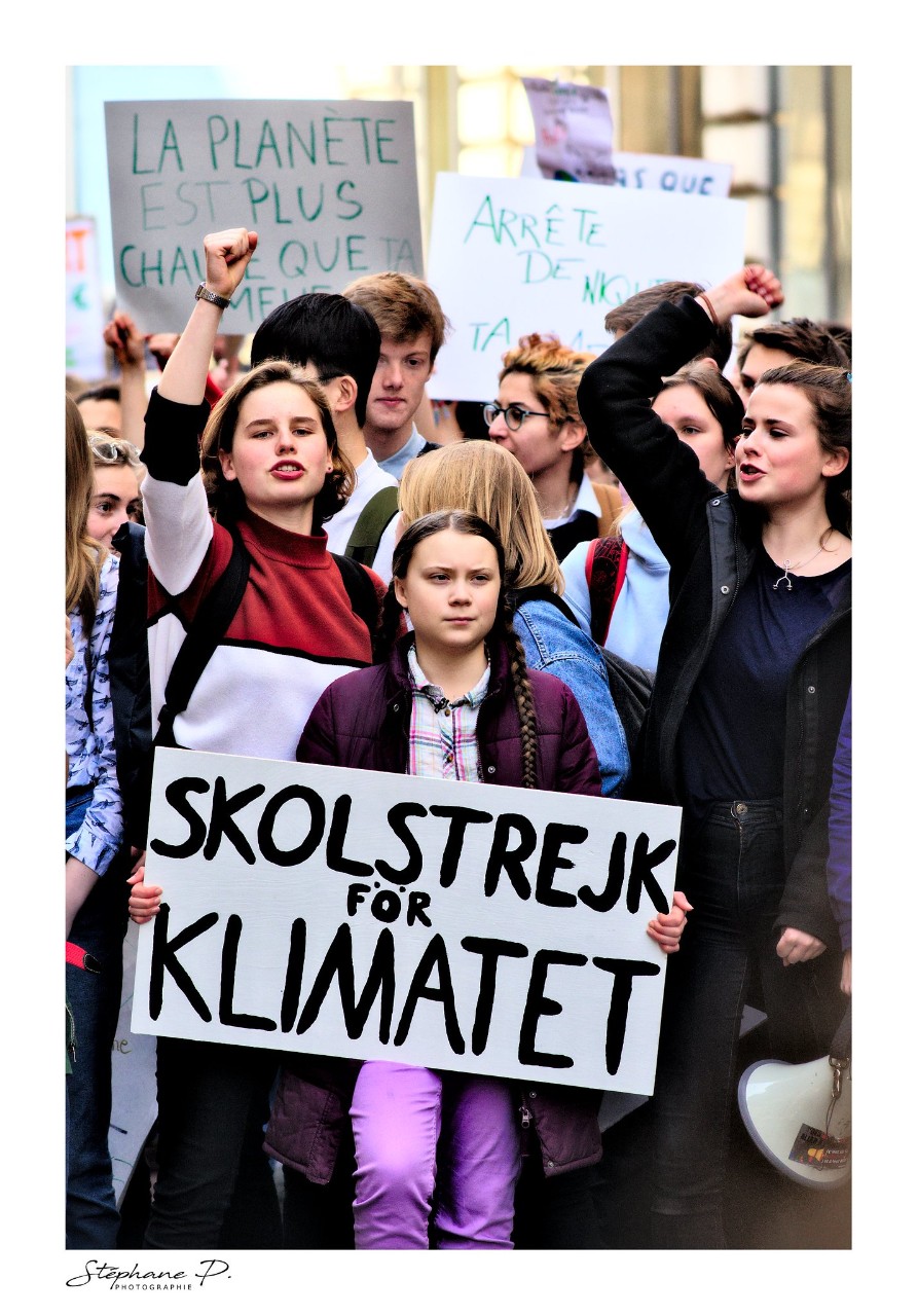 photo of young activist Greta Thunberg holding a sign that says School Strike for Climate