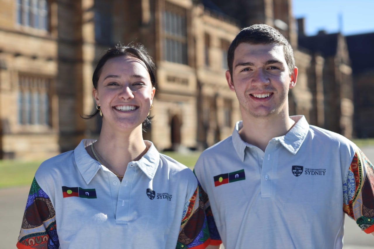 Students Charlie Jackson and Tyler Kennedy in front of the Quadrangle building