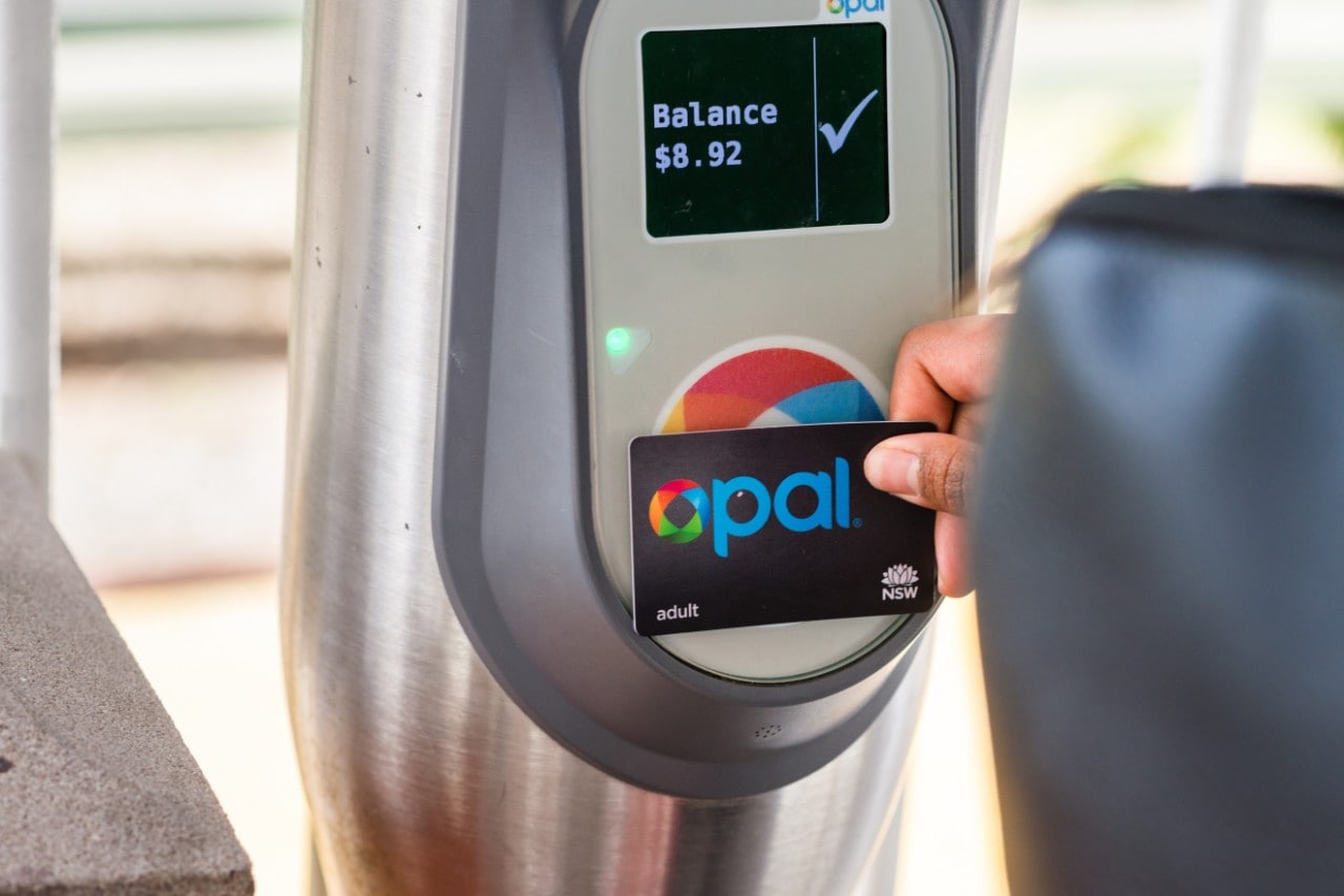 Opal card being pressed to a reader with the card balance displaying on the screen