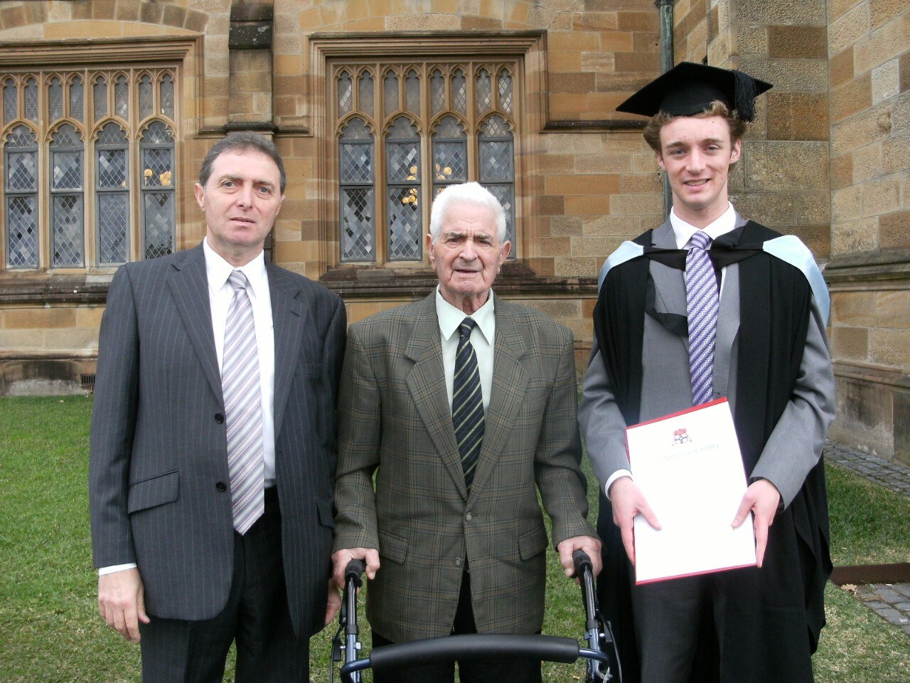 Guy Boncardo stands with his father and his son at his son's University of Sydney graduation ceremony