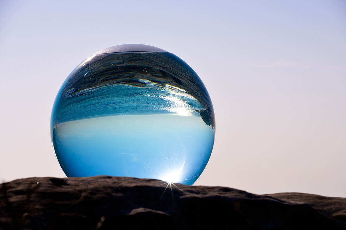 Horizon 2018, by Lucy Humphrey - sculpture featuring a giant water-filled ball overlooking the ocean. Photo by Clyde Yee. 