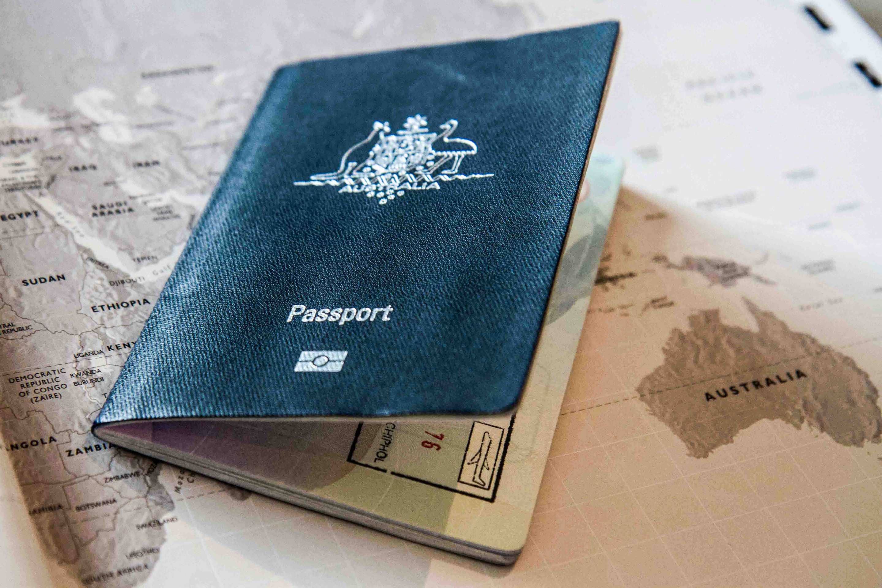 An Australian passport on a world map.