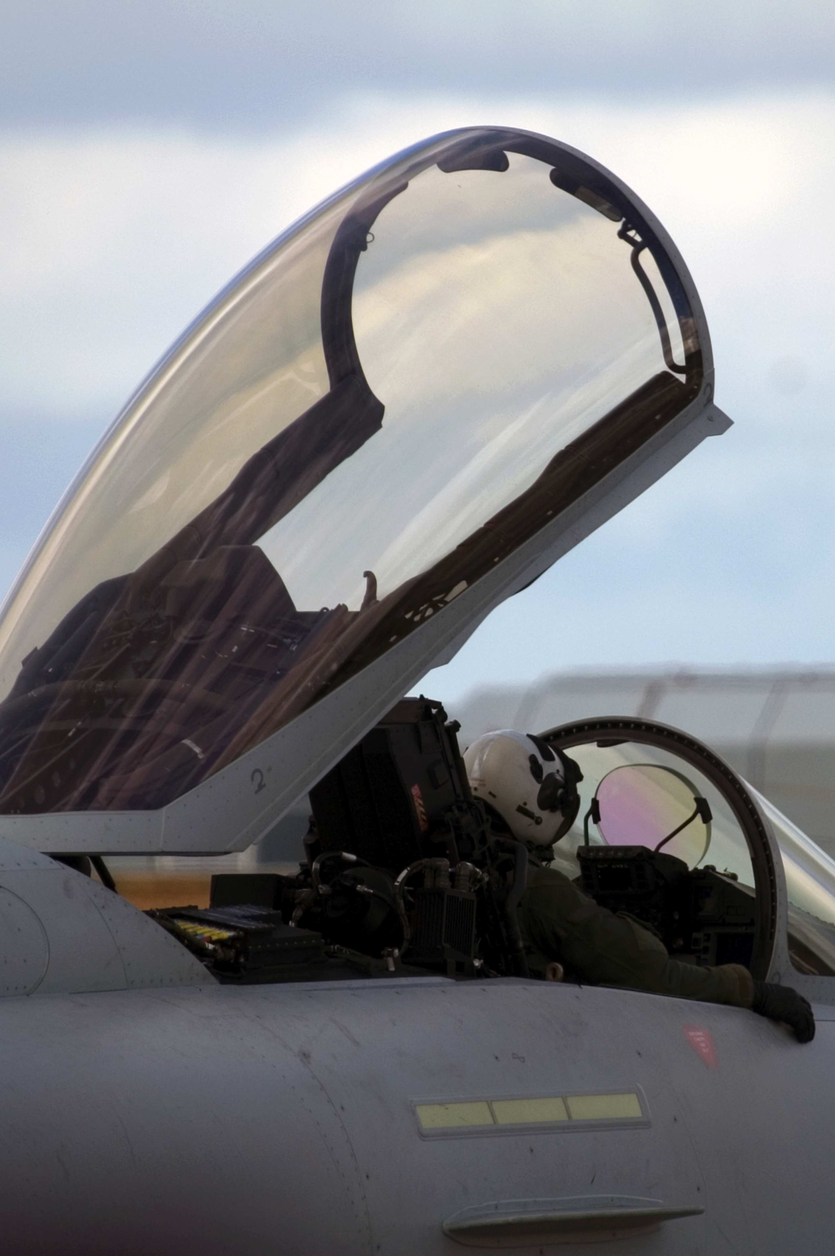 An airforce pilot sits grounded in a fighter jet with the cockpit window ajar. Image: iStock