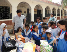 Lila Ram with a group of Pakistani school kids