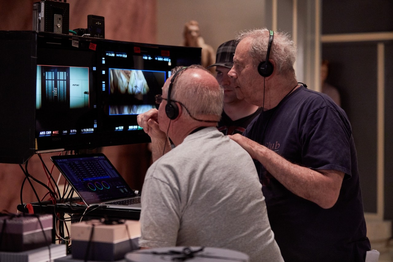 Beresford (R), discusses shots with cinematographer, Peter James.