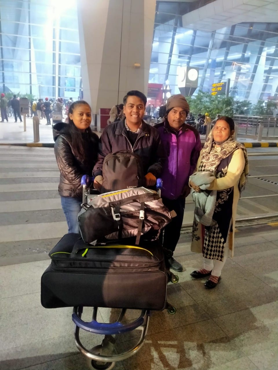 Tushar Joshi and his family carrying luggages, leaving India