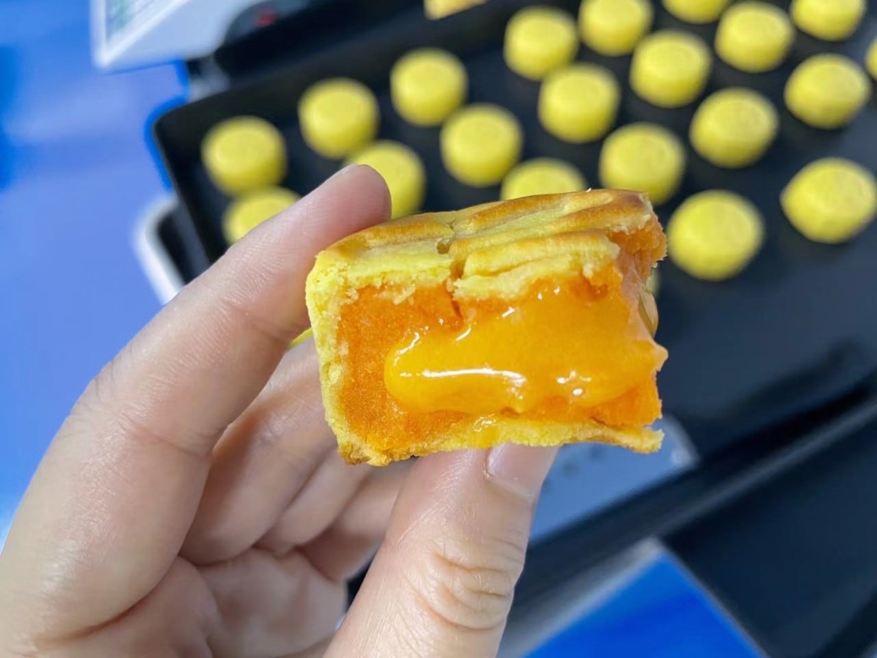 The inside of a lava egg mooncake, yellow, and liquid filling of the yolk