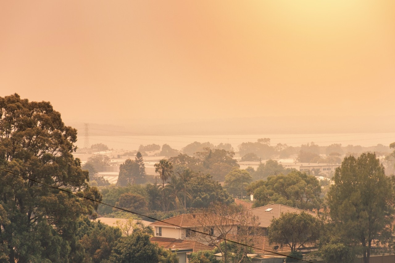 Horizon shot of suburban landscape shrouded with orange haze 