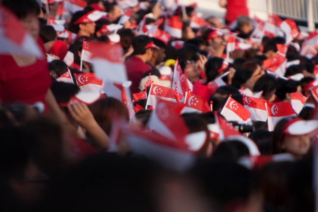 Crowd holding Singapore flags
