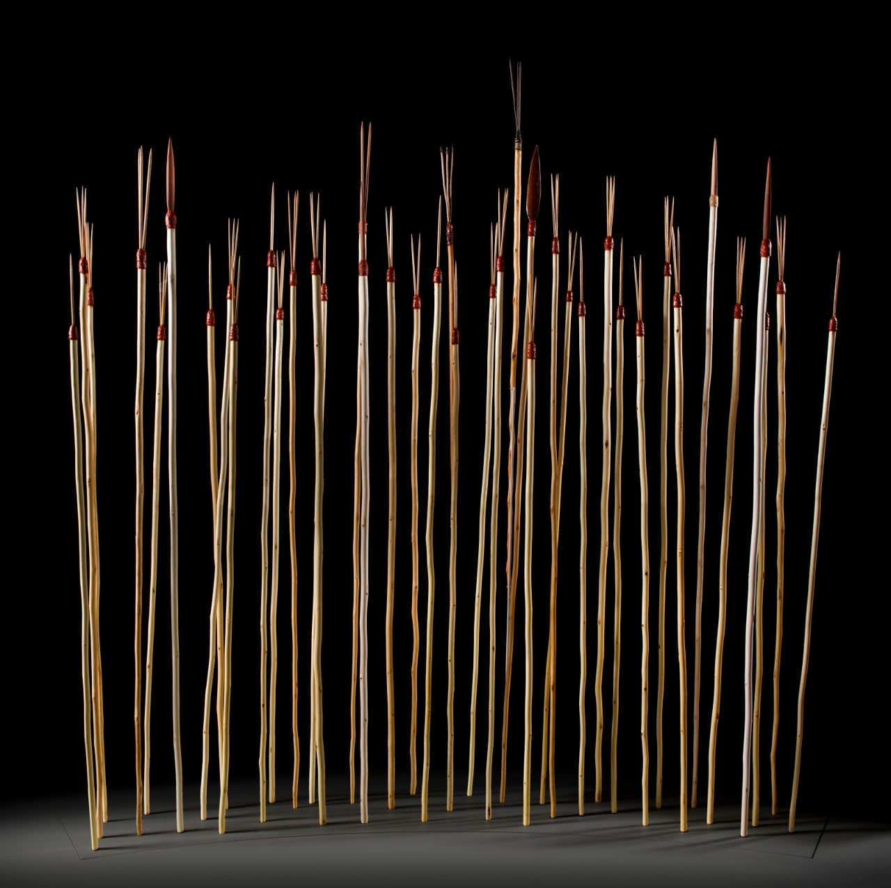 A display includes 37 contemporary spears on a dark background